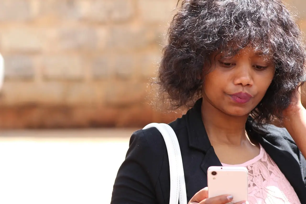 Someone reading a message on their phone, looking concerned
